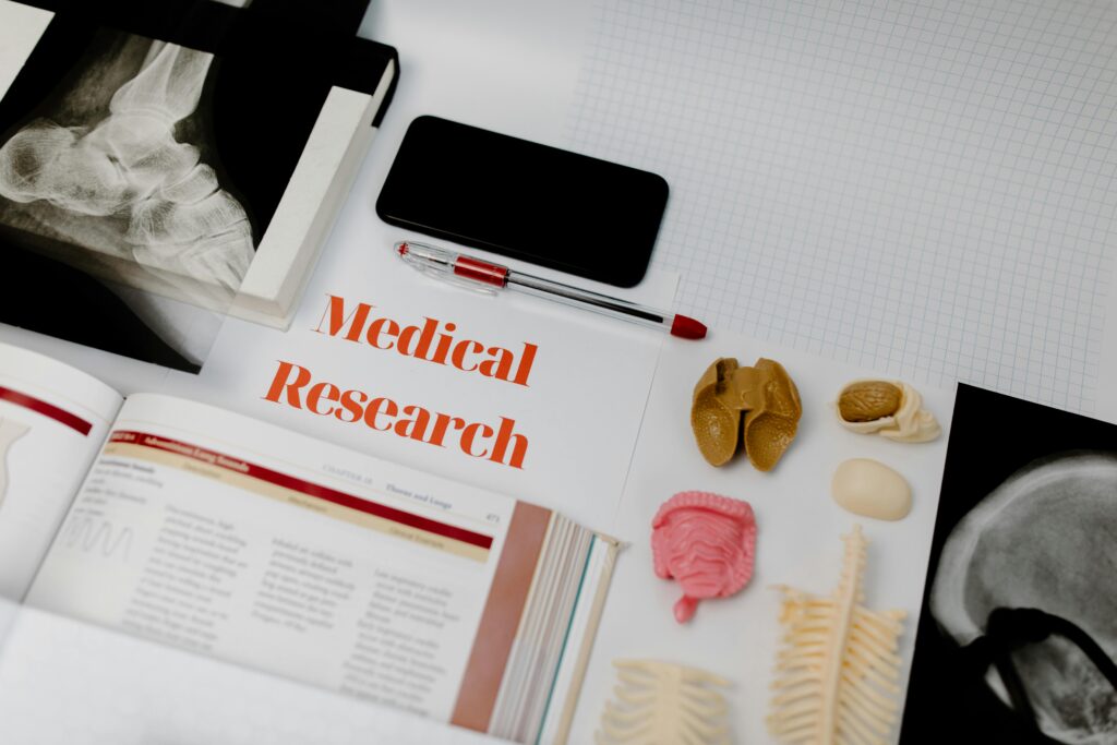 pexels-photo-7723391-7723391 Medical research setup featuring anatomical models, x-rays, and a textbook, ideal for educational purposes.